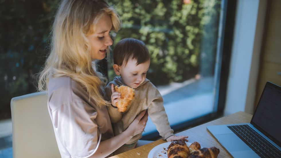 woman and her son eating croissants