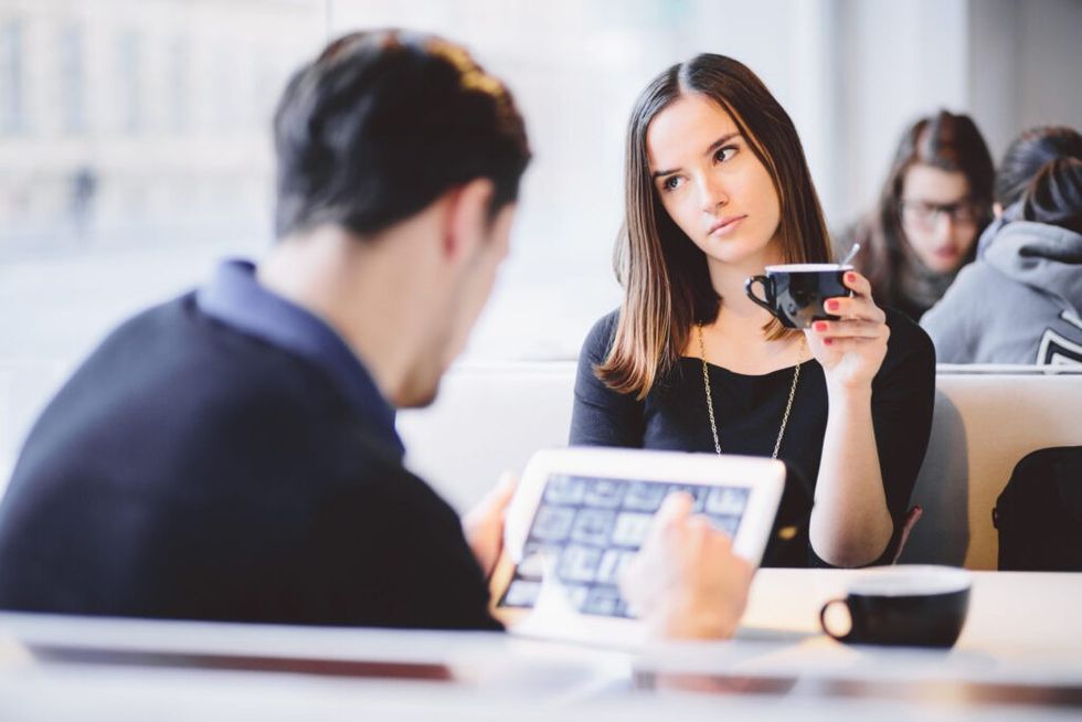 Woman-annoyed-at-table-with-boyfriend