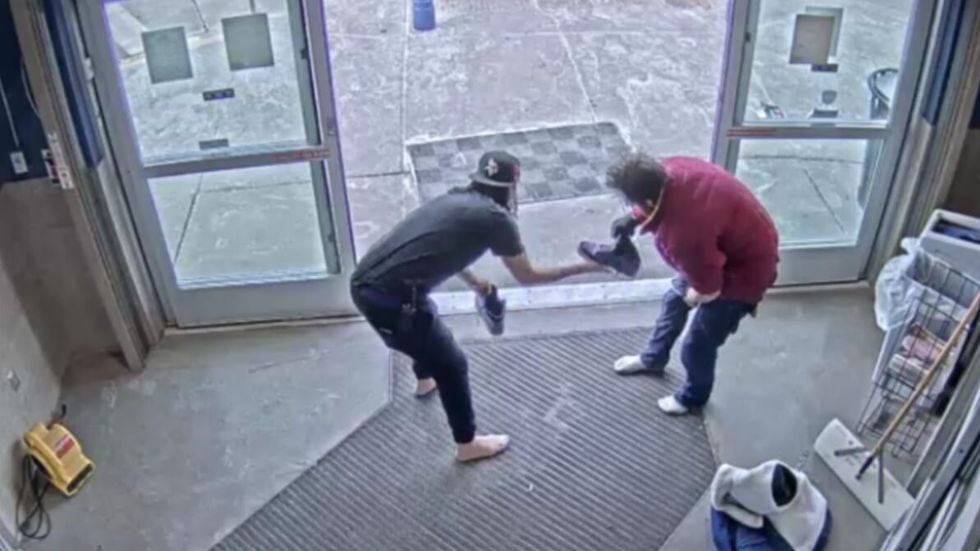 woman giving a man the shoes off of her feet