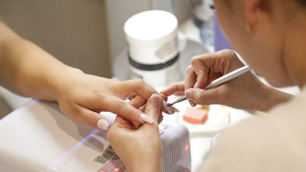 woman giving a manicure to a person