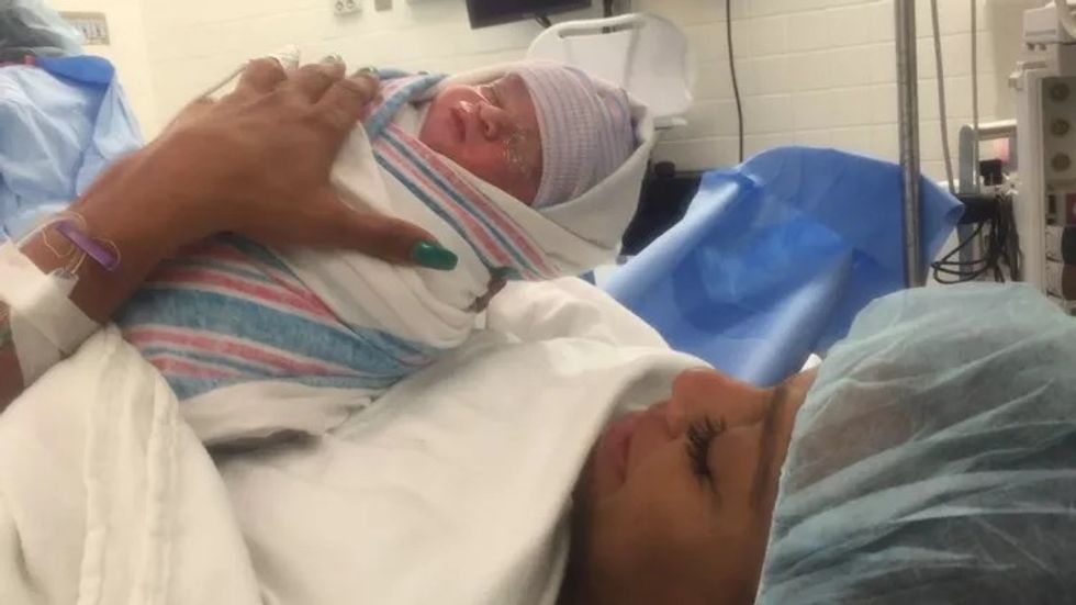 woman holding her newborn son