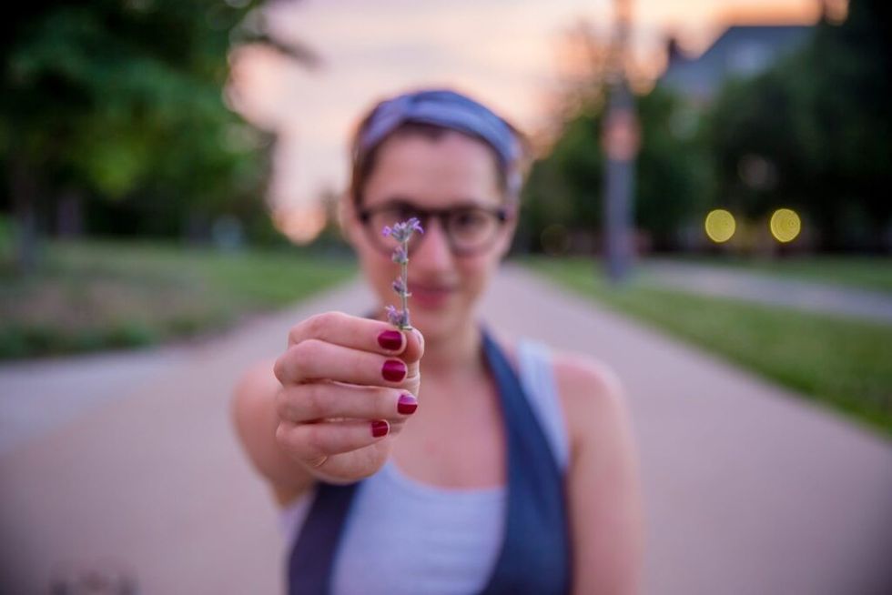 woman-holding-out-flower
