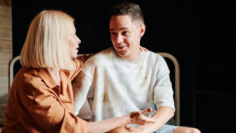 woman hugging a younger man