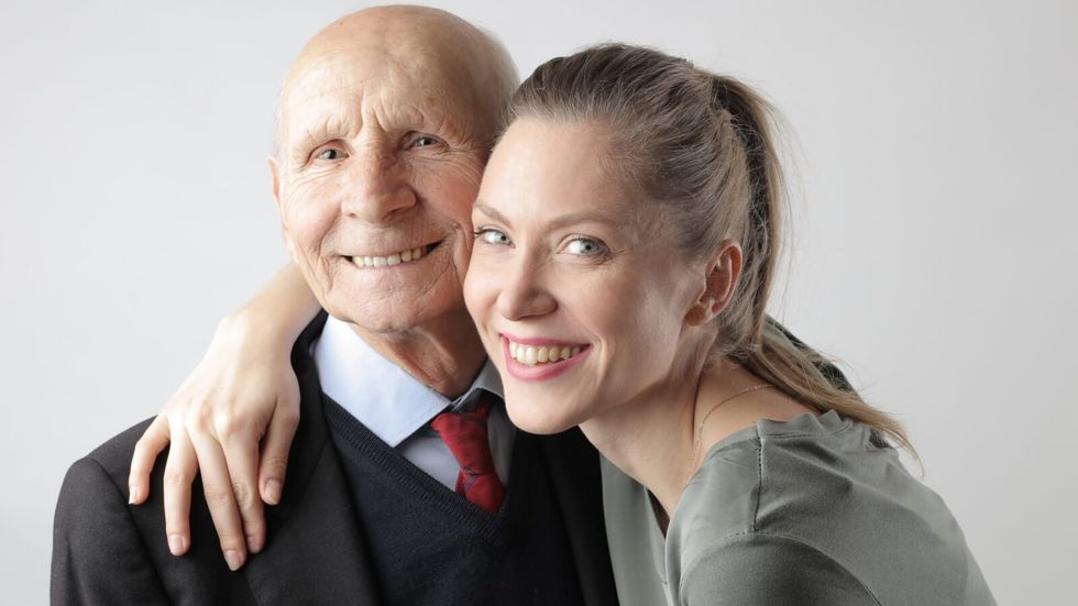 woman hugging elderly man