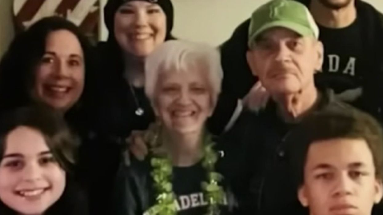 Woman in a Philadelphia Eagles sweater posing for photo with her family