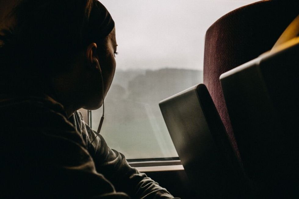Woman-looking-out-a-bus-window