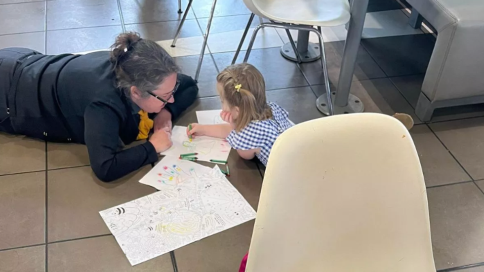 woman lying on the floor with a little girl