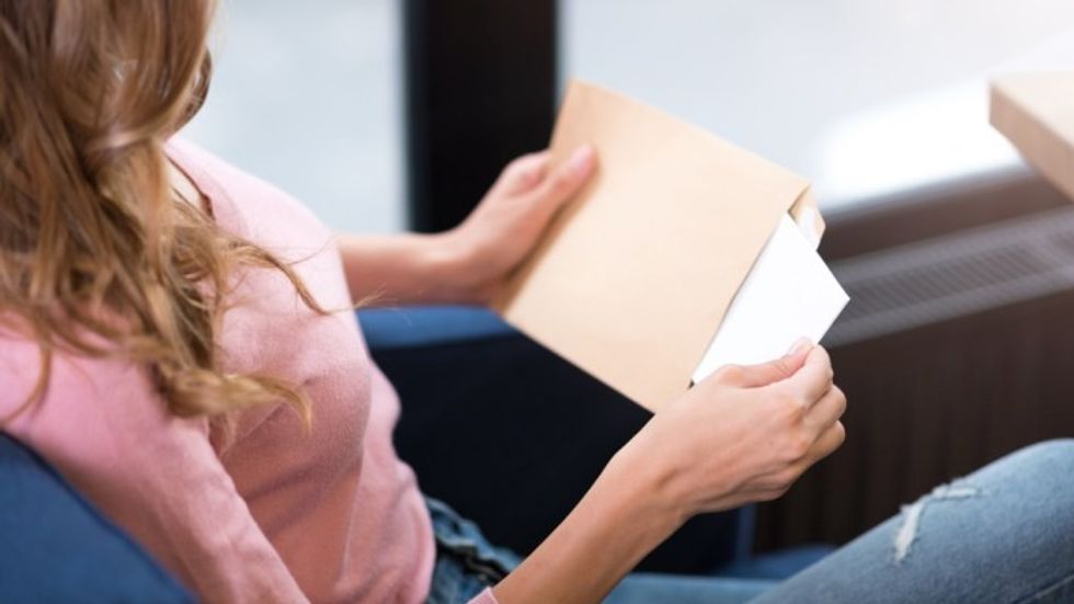 Woman opening envelope