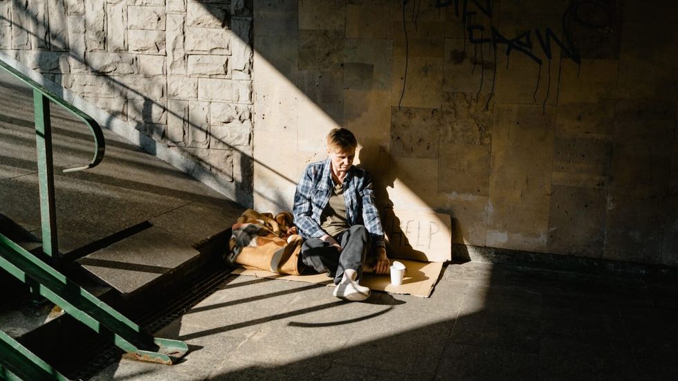 woman sitting on the ground near the stairs
