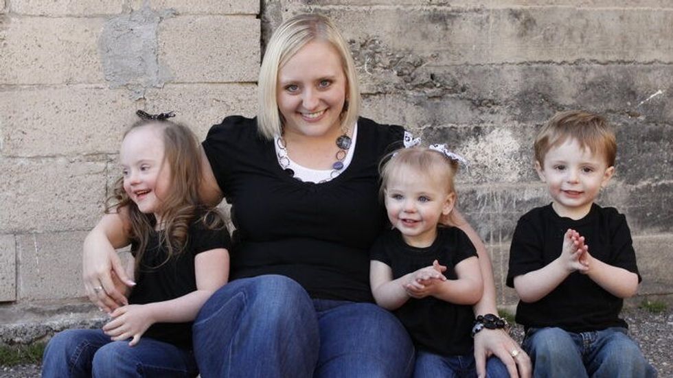 woman sitting with three children