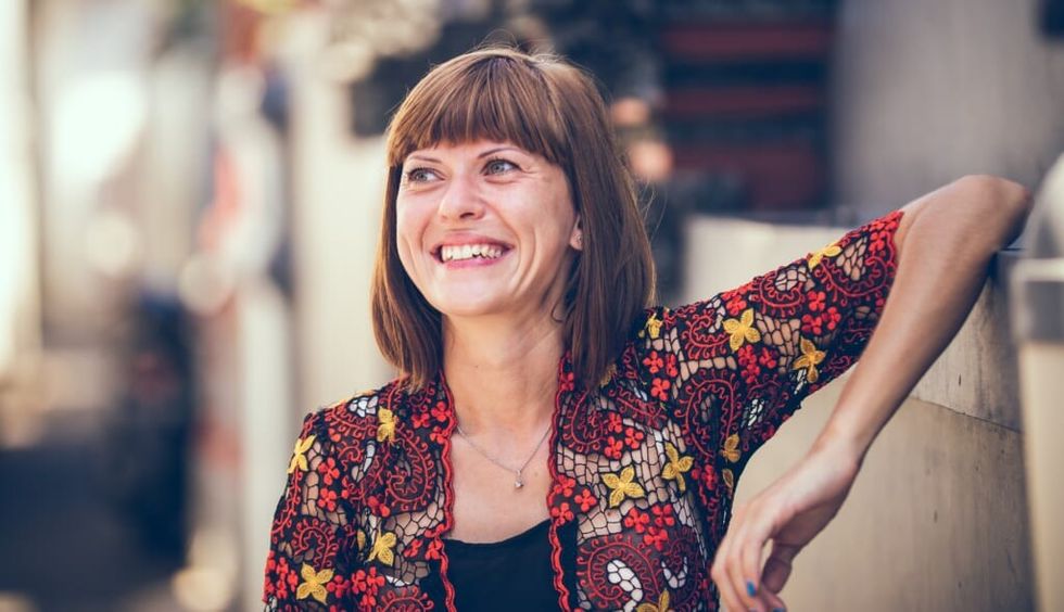 woman smiles widely grateful