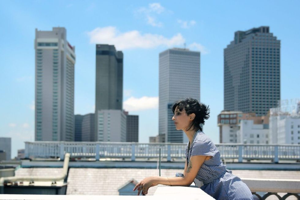 Woman-standing-on-city-terrace