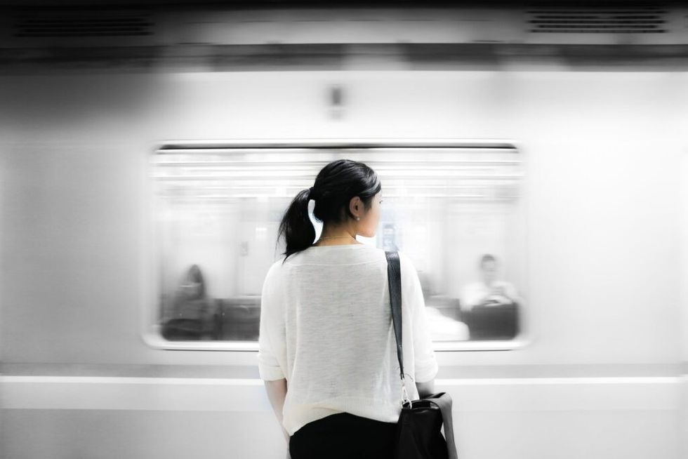 Woman-standing-on-subway-platform