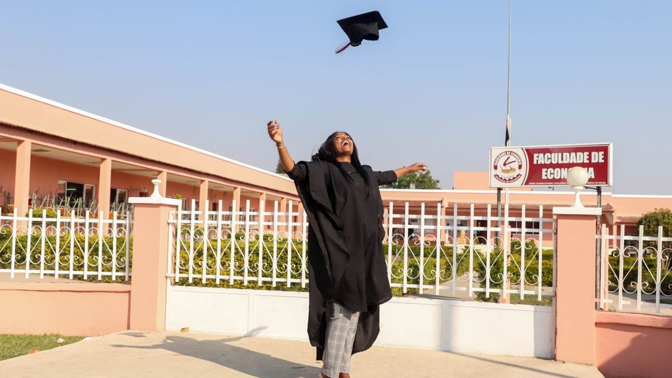 woman throwing her graduation cap in the air