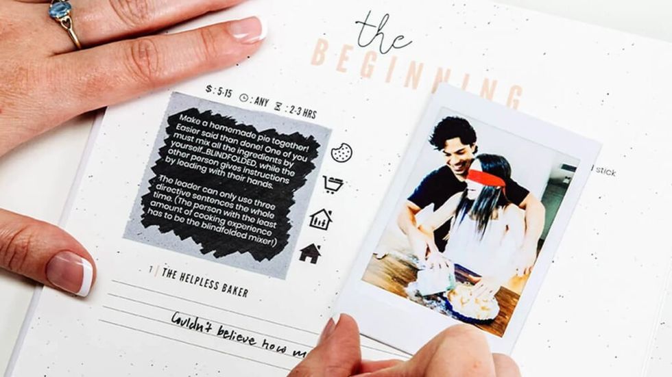 woman wearing a blue ring writing in the Adventure Challenge Couples Edition book