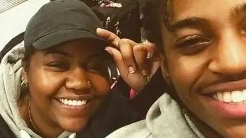 woman wearing a cap and smiling with her son