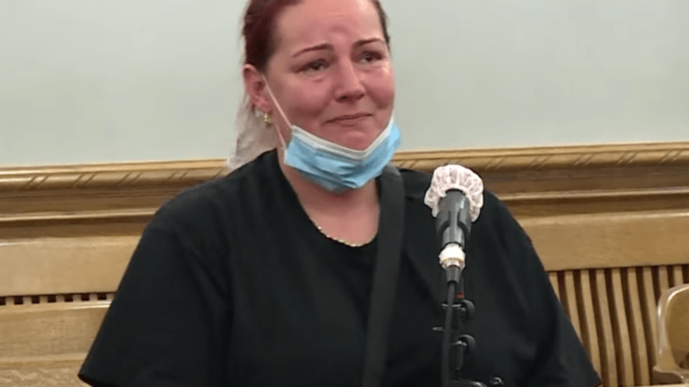 woman wearing a face mask in a courtroom