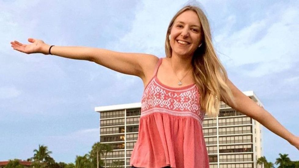 woman with her hands held wide