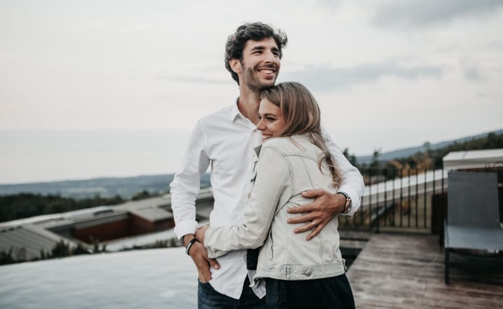 young couple hugging wearing white