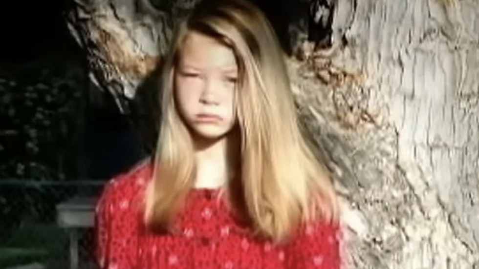 young girl wearing a red dress
