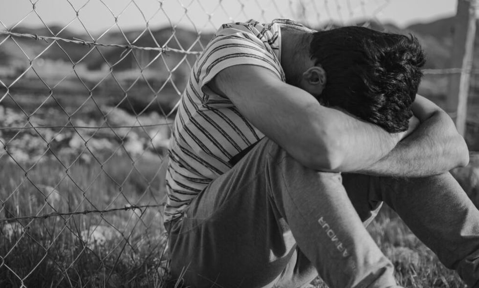 young man cries outside