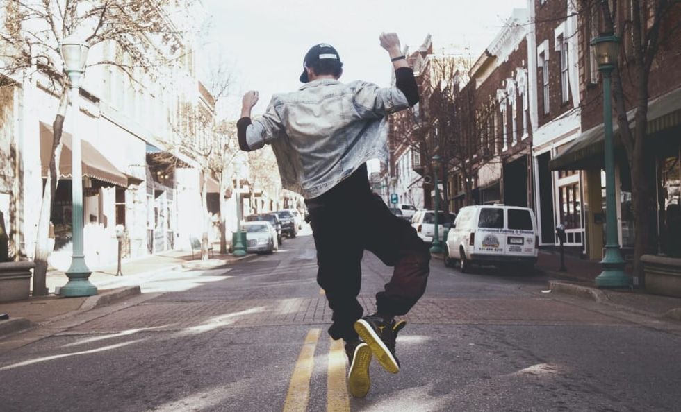 young man dances in the street