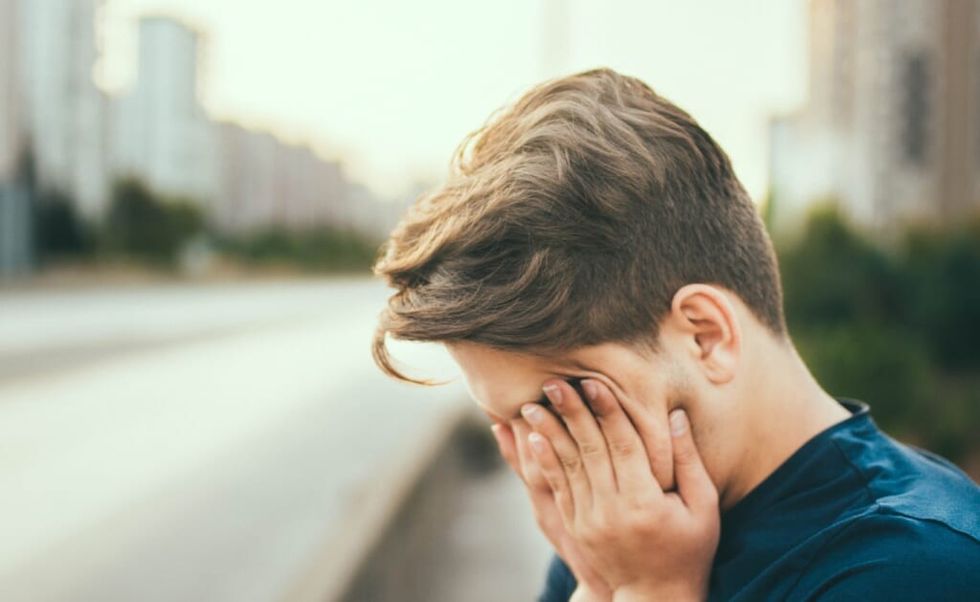 young man is tired outside