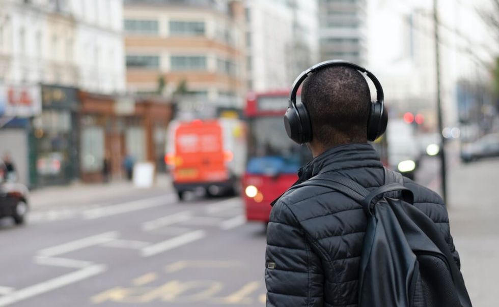 young man listens to music with headphones