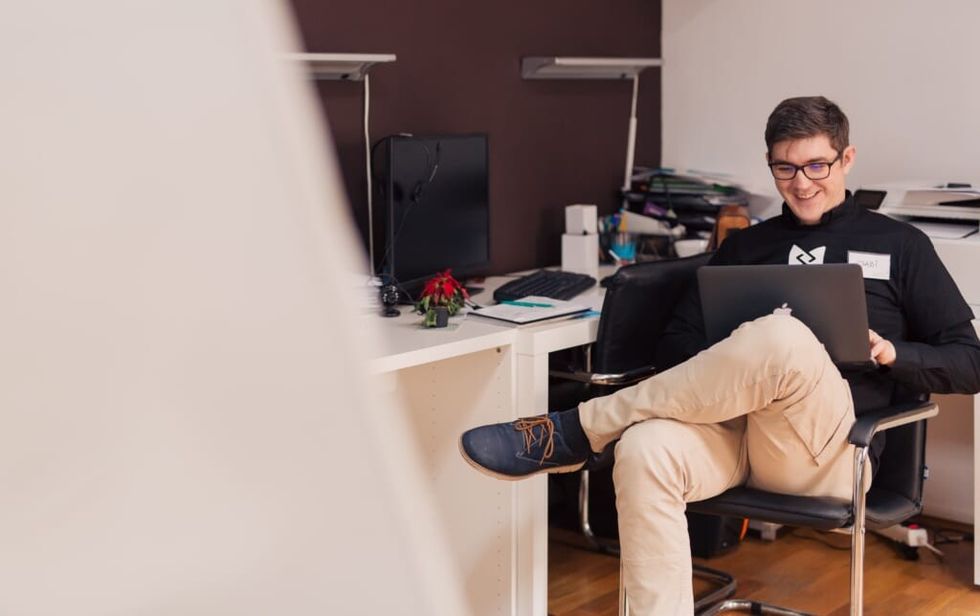 young man relaxes in office chair