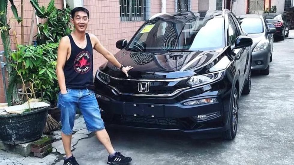 young man standing next to a car