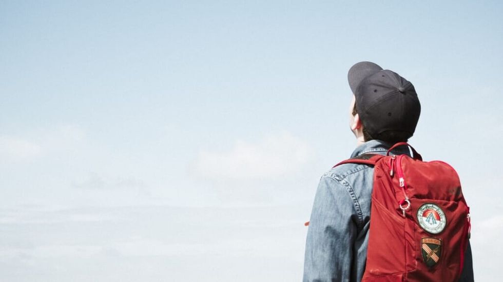 young student looks up at the sky