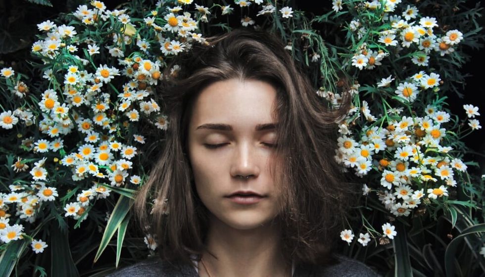 young woman head in the flowers