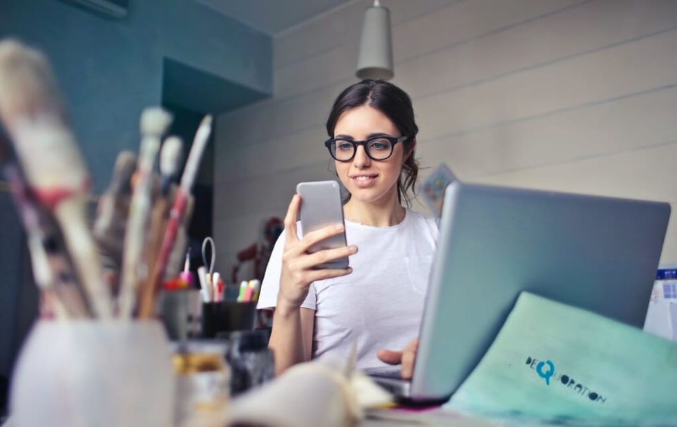 young woman looks at phone