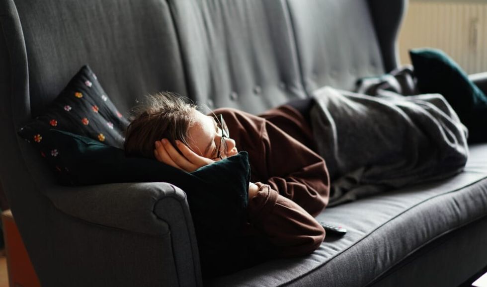 young woman on couch watching television