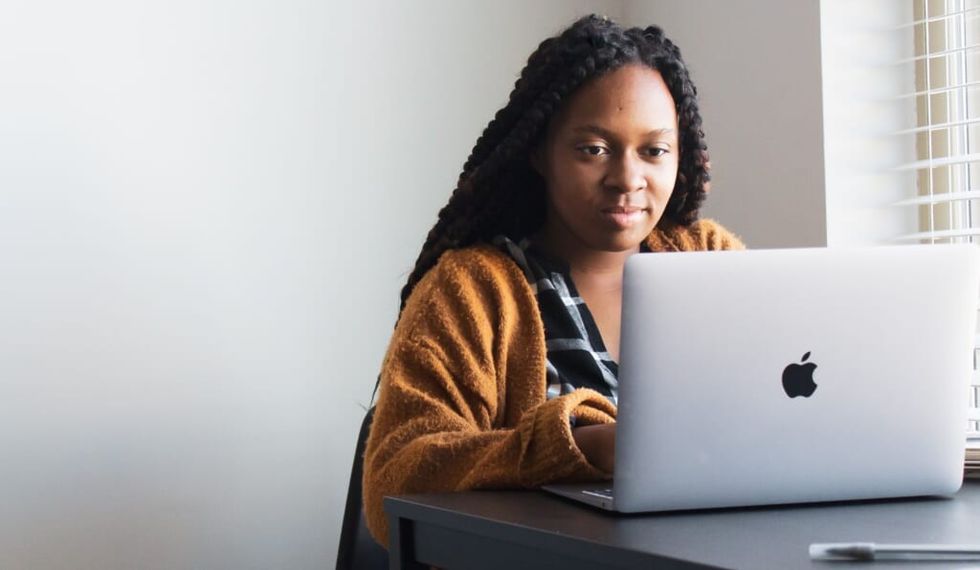 young woman writes on her laptop
