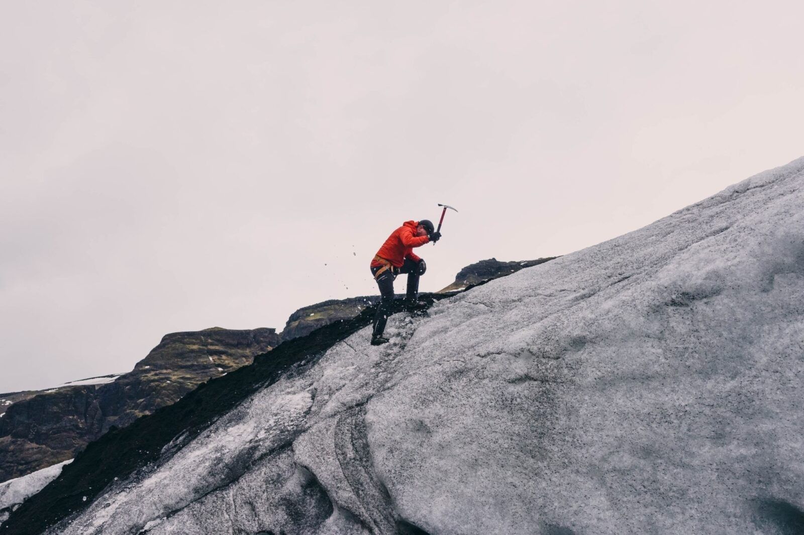 man-climbing-glacier