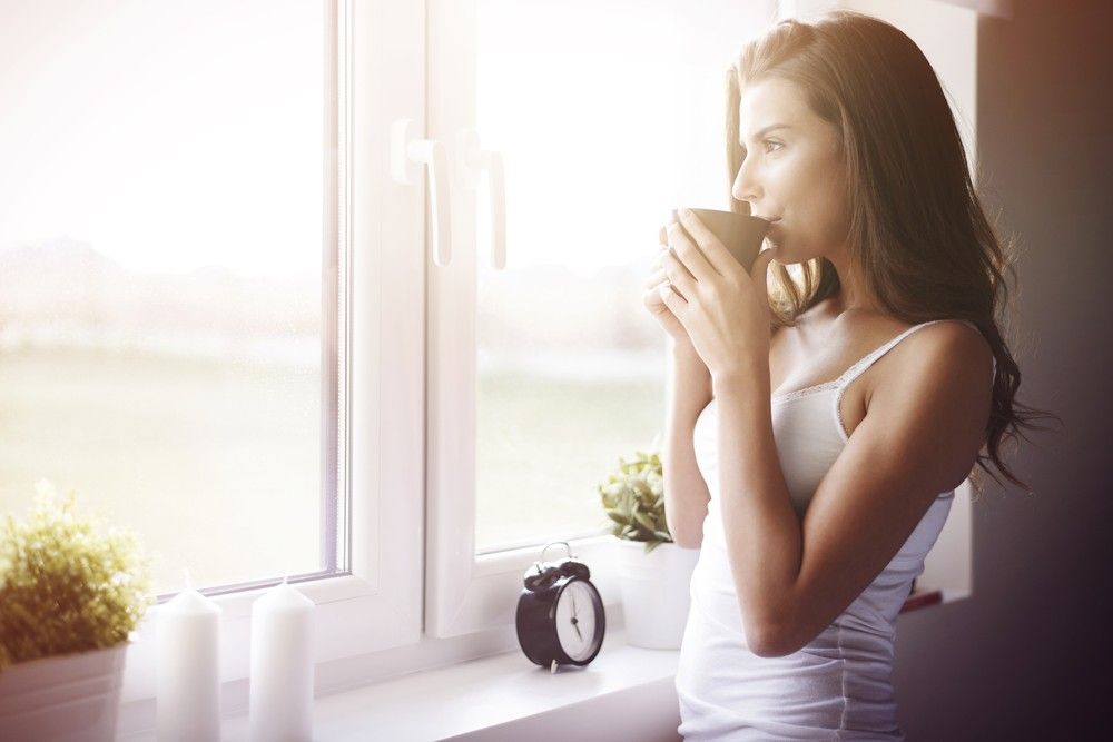 woman-waking-up-sipping-coffee