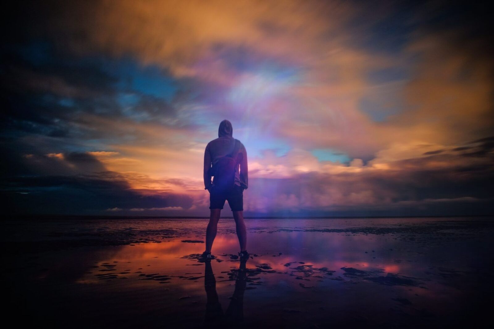 mentally-strong-man-standing-tall-eerie-cloudy-sunset-scenery