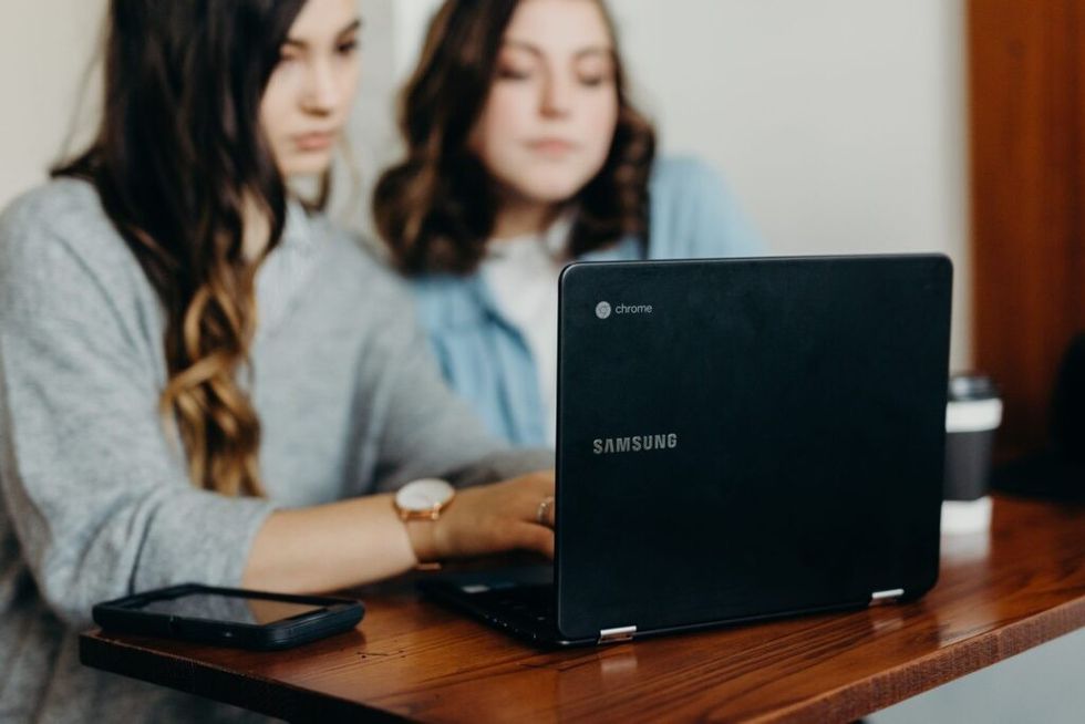 Two-women-looking-at-a-laptop