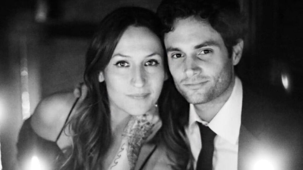 Penn Badgley and Domino Kirke attend a wedding