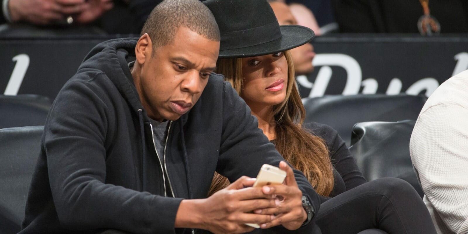 Beyonce looking at Jay Z's phone