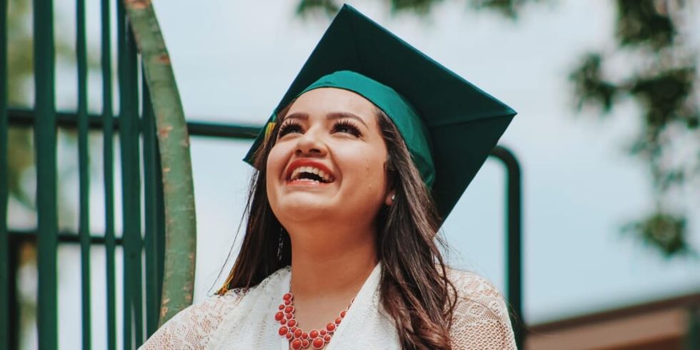 Girl smiling wearing graduation cap by Juan Ramos on Unsplash