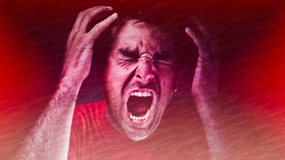 Angry man screaming red background