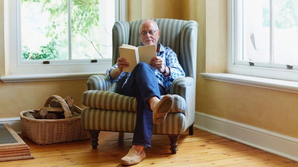 old man reading book