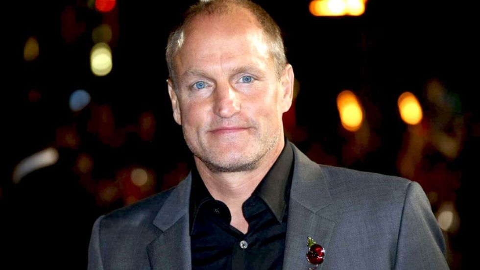 Woody Harrelson in a grey suit and black shirt