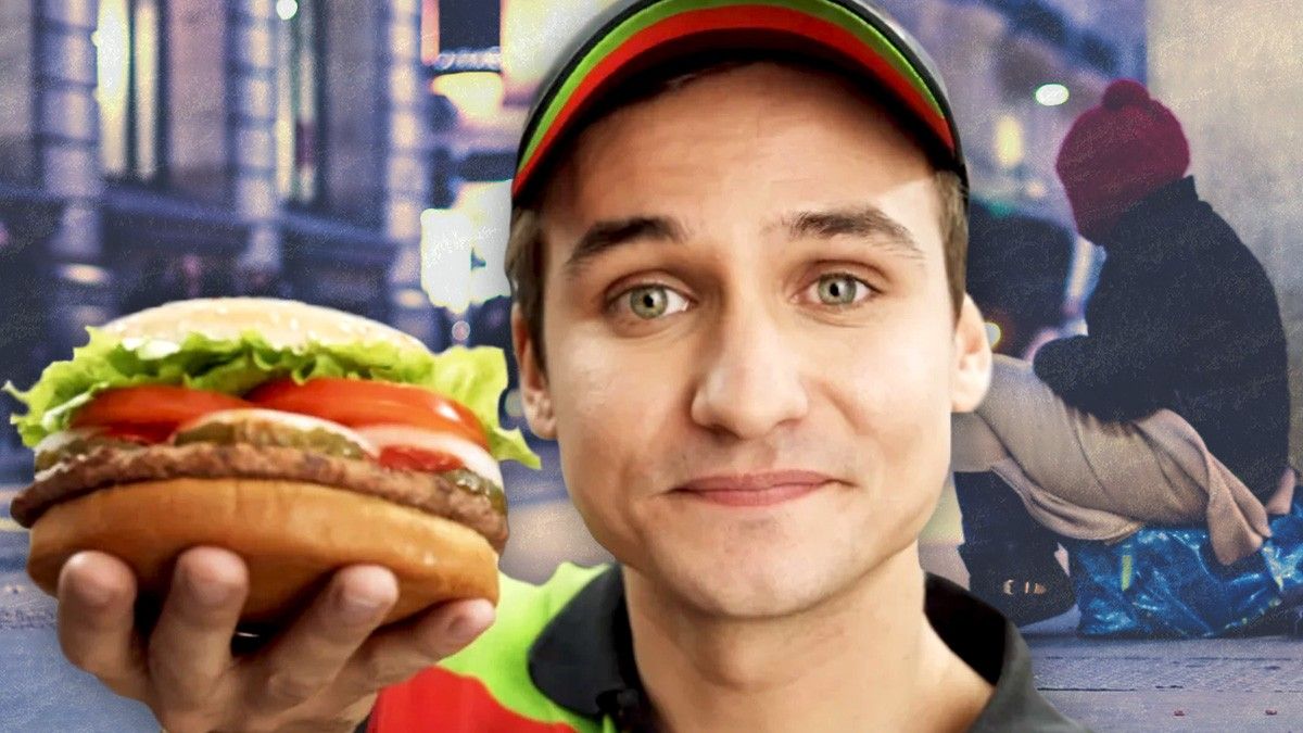 Burger King employee offers whopper with homeless man in background