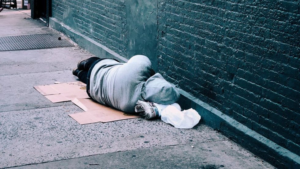 Homeless woman lying in the street