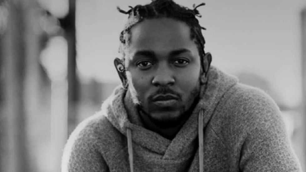 Kendrick Lamar squatting black and white