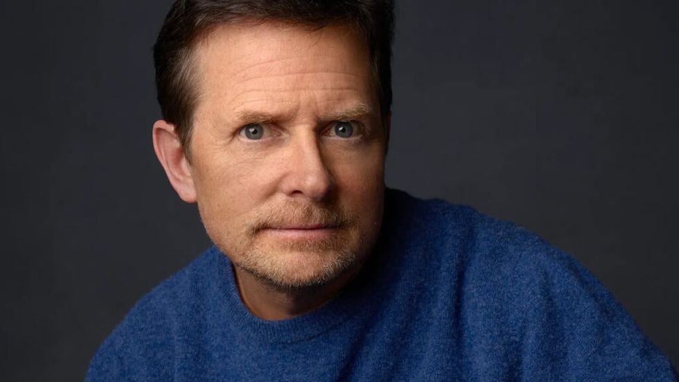 Michael J. Fox looking intense wearing a blue sweater