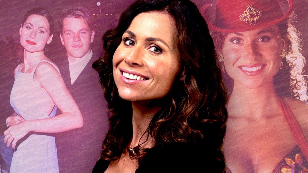 Minnie Driver smiling in front of pic with Matt Damon and Goldeneye